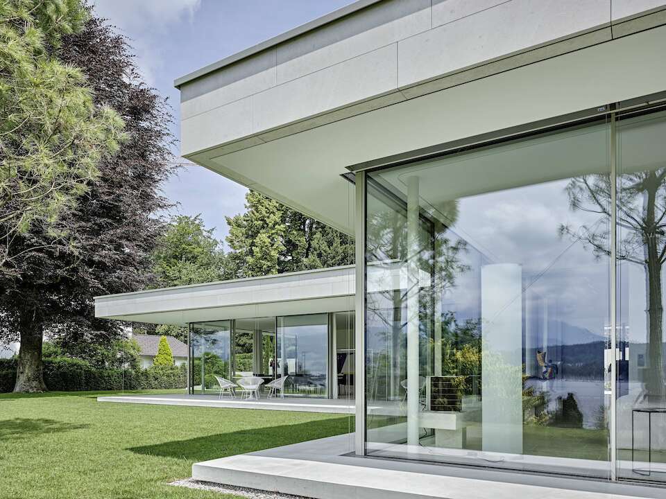 Glass house villa with large sliding windows from swissFineLine